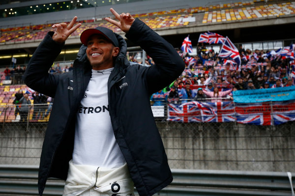 Shanghai International Circuit, Shanghai, China.  Sunday 09 April 2017. 
Lewis Hamilton, Mercedes AMG, celebrates victory in front of a grandstand filled with fans waving British flags.
World Copyright: Andrew Hone/LAT Images 
ref: Digital Image _ONZ6499