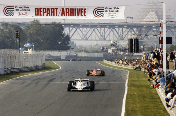 Alan Jones, Williams FW07 Ford celebrates victory as he crosses the finish line ahead of Gilles Villeneuve, Ferrari 312T4.