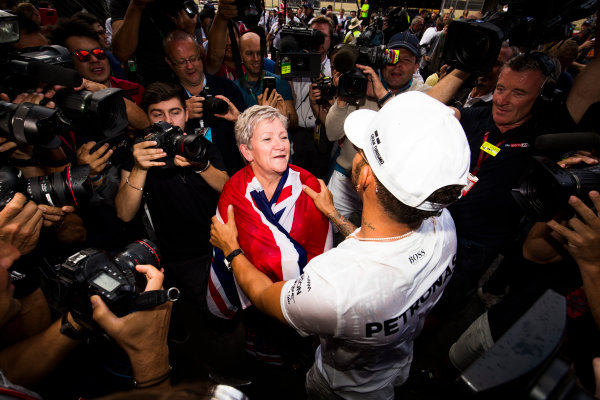 Autodromo Hermanos Rodriguez, Mexico City, Mexico.
Sunday 29 October 2017.
Lewis Hamilton, Mercedes AMG, celebrates his 4th world drivers championship title with his mother Carmen Larbalestier, surrounded by a large crowd of photographers.
World Copyright: Sam Bloxham/LAT Images 
ref: Digital Image _W6I1586