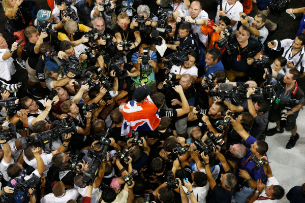 Yas Marina Circuit, Abu Dhabi, United Arab Emirates.
Sunday 23 November 2014.
Lewis Hamilton, Mercedes AMG, 1st Position, celebrates with his team.
World Copyright: Charles Coates/LAT Photographic.
ref: Digital Image _J5R7460