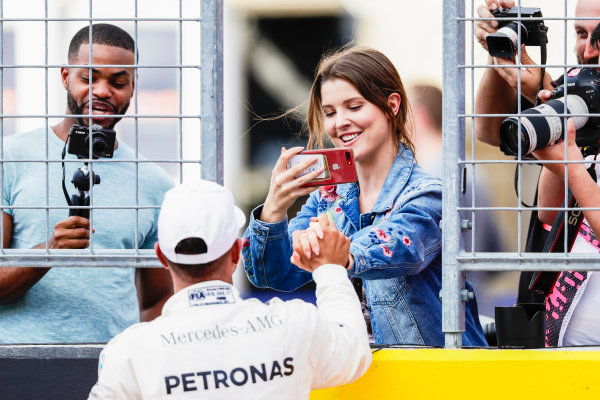 Circuit of the Americas, Austin, Texas, United States of America.
Saturday 21 October 2017.
Lewis Hamilton, Mercedes AMG, celebrates on the grid with a friend after securing pole.
World Copyright: Zak Mauger/LAT Images 
ref: Digital Image _56I1823