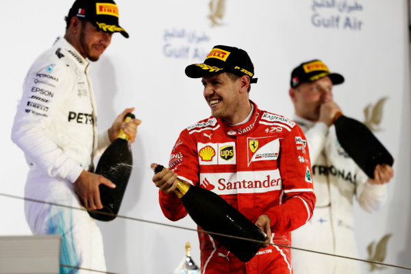 Bahrain International Circuit, Sakhir, Bahrain. 
Sunday 16 April 2017.
Sebastian Vettel, Ferrari, celebrates on the podium with Lewis Hamilton, Mercedes AMG, and Valtteri Bottas, Mercedes AMG.
World Copyright: Charles Coates/LAT Images
ref: Digital Image _27I0977