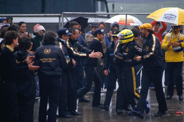 1985 Portuguese Grand Prix.Estoril, Portugal.19-21 April 1985.Ayrton Senna (Team Lotus) celebrates his maiden F1 win after an awesome drive in the rain soaked race. He is mobbed by team collegues, who haven't seen a victory at Lotus in nearly three years. Ref-85 POR 01.World Copyright - LAT Photographic 1985 Portuguese Grand Prix.Estoril, Portugal.19-21 April 1985.Ayrton Senna (Team Lotus) celebrates his maiden F1 win after an awesome drive in the rain soaked race. He is mobbed by team collegues, who haven't seen a victory at Lotus in nearly three years. Ref-85 POR 01.World Copyright - LAT Photographic