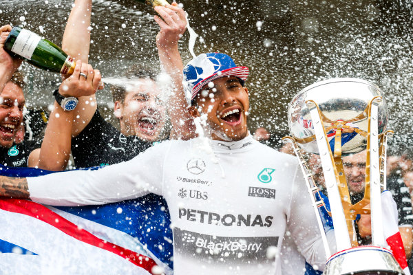 Circuit of the Americas, Austin, Texas, United States of America. 
Sunday 25 October 2015.
Lewis Hamilton, Mercedes AMG, 1st Position, gets a Champagne soaking from his team after securing a third World Drivers Championship victory.
World Copyright: Alastair Staley/LAT Photographic
ref: Digital Image _79P4353
